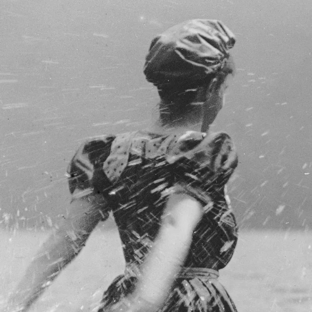 Woman on beach, splashing water.